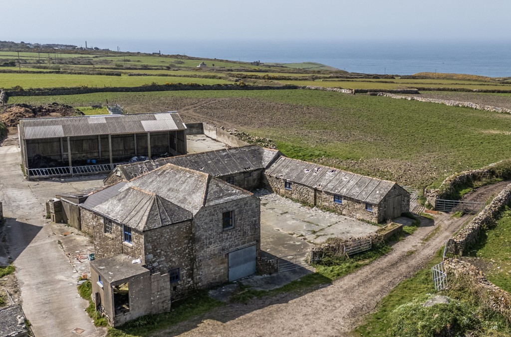 Lot: 3 - COMPLEX OF GRANITE BARNS, DUTCH BARN, CATTLE SHED FARMYARD AND LAND WITH POTENTIAL - Aerial view of all barns